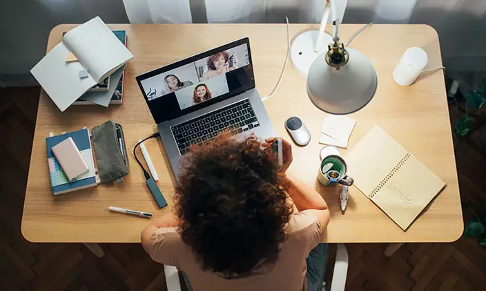Woman on virtual meeting while working from home