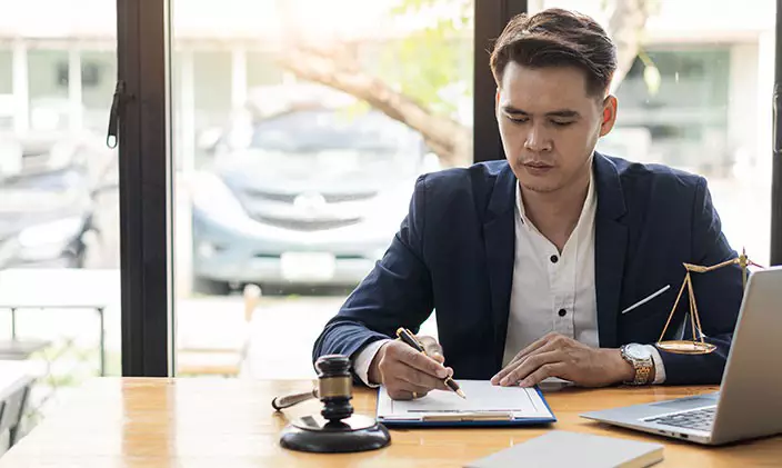 Young criminal justice professional looking over contract 