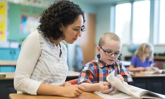 Early education teacher working with child 